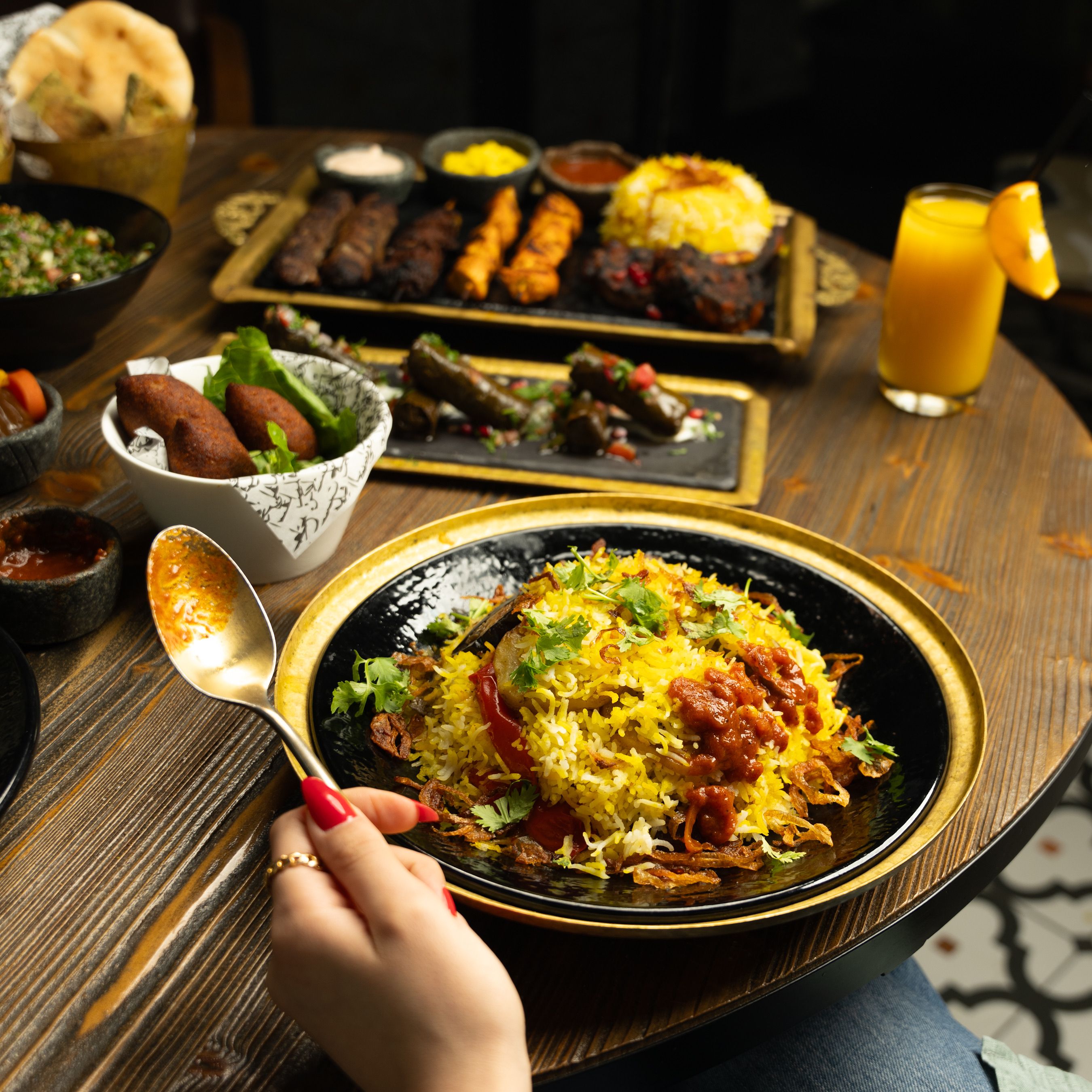 100% vegetarian dum biryani served in a copper handi, garnished with saffron and mint